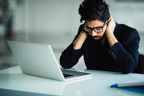 Developer studying and writing in notebook